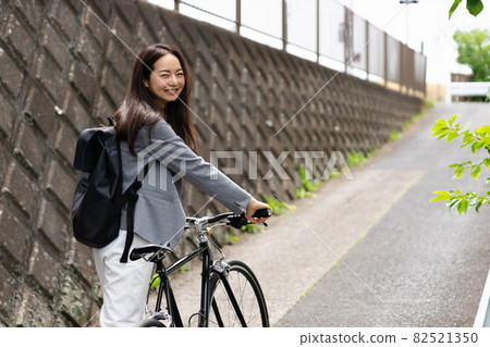 Image of women and bicycles commuting with a smile Image of women and bicycles commuting with a smile 82521350