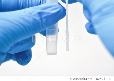 Medical personnel compare a cotton swab and saline extraction tube for diagnostic covid-19 Medical personnel compare a cotton swab and saline extraction tube for diagnostic covid-19 82521900