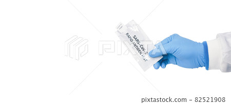 Medical personnel hand showing envelope of Covid-19 antigen rapid test kit on white background Medical personnel hand showing envelope of Covid-19 antigen rapid test kit on white background 82521908
