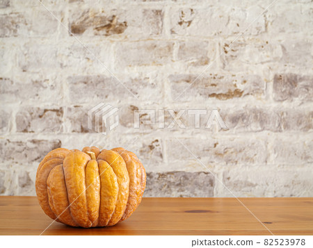 Orange pumpkin against a brick background Orange pumpkin against a brick background 82523978