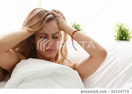 young woman is ill stay in bed have a headacke young woman is ill stay in bed have a headacke 82524779