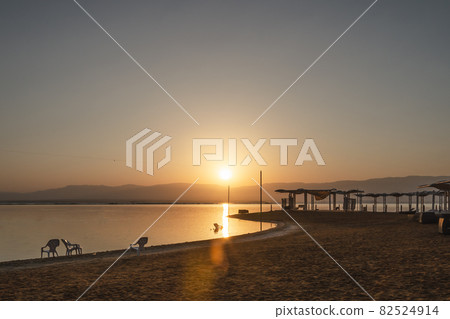 sunrise on the Dead Sea overlooking the beach and water sunrise on the Dead Sea overlooking the beach and water 82524914