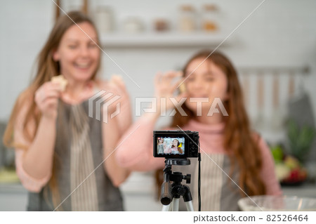 Close up camera is using by family for online live streaming during cooking in the kitchen 82526464