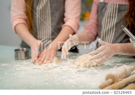 Close up hand of two woman thresh flour for cooking with other tools or accessories in the kitchen 82526465