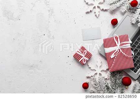 Christmas and New Year flat lay with laptop computer, credit card, gift boxes 82528650