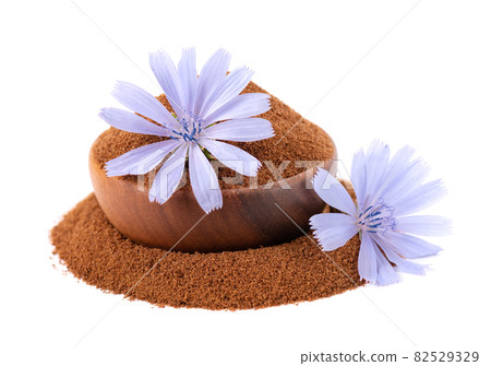Chicory powder and flower in wooden bowl, isolated on white background. Cichorium intybus. 82529329