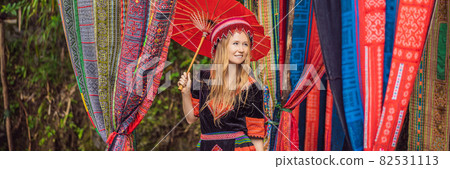 BANNER, LONG FORMAT female tourist dressed in the traditional dress of the inhabitants of the Vietnamese mountains, the Hmong. Woman in Sapa in the fog, Northwest Vietnam. Vietnam travel concept BANNER, LONG FORMAT female tourist dressed in the traditional dress of the inhabitants of the Vietnamese mountains, the Hmong. Woman in Sapa in the fog, Northwest Vietnam. Vietnam travel concept 82531113