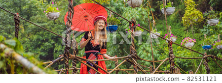 BANNER, LONG FORMAT female tourist dressed in the traditional dress of the inhabitants of the Vietnamese mountains, the Hmong. Woman in Sapa in the fog, Northwest Vietnam. Vietnam travel concept BANNER, LONG FORMAT female tourist dressed in the traditional dress of the inhabitants of the Vietnamese mountains, the Hmong. Woman in Sapa in the fog, Northwest Vietnam. Vietnam travel concept 82531121
