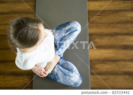 Young attractive woman does yoga exercise in the gym on mat Young attractive woman does yoga exercise in the gym on mat 82533442
