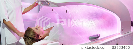 Modern spa treatment capsule in cosmetology clinic, cosmetologist operating equipment Modern spa treatment capsule in cosmetology clinic, cosmetologist operating equipment 82533460