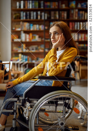 Thoughtful disabled female student in wheelchair 82533654
