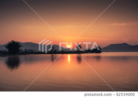 Sunrise over mountain range on Lam Taphoen reservoir in countryside Sunrise over mountain range on Lam Taphoen reservoir in countryside 82534000