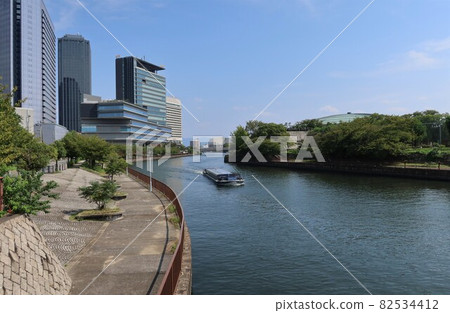 Japanese river scenery: Daini Neya River flowing through Osaka city and buildings of Osaka Business Park Japanese river scenery: Daini Neya River flowing through Osaka city and buildings of Osaka Business Park 82534412