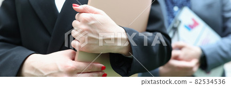 Businesswoman and businessman holding documentation in their hands Businesswoman and businessman holding documentation in their hands 82534536