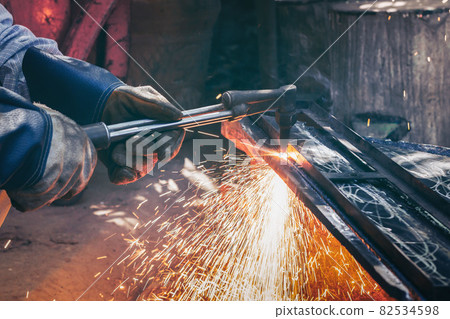 Close up hand heavy industrial worker is working on metal work factory process by Cutting sheet Close up hand heavy industrial worker is working on metal work factory process by Cutting sheet 82534598