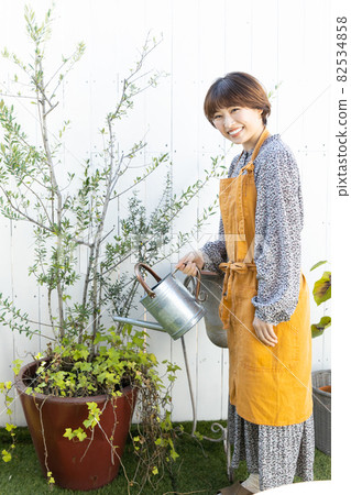 A woman enjoying gardening 82534858