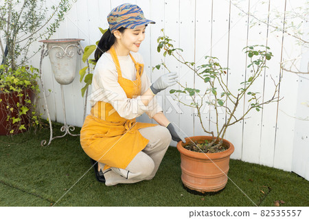 A woman enjoying gardening A woman enjoying gardening 82535557