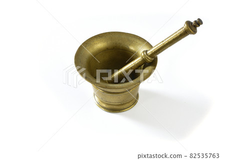 September 2021. copper mortar with pestle on a white background. September 2021. copper mortar with pestle on a white background. 82535763