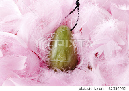 vaginal jade egg on pink feathers 82536062