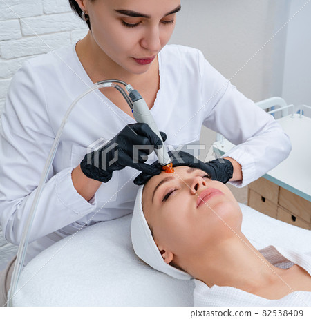 Face Skin Care. Closeup Of Woman Face Cleansing At Cosmetology clinic, vacuum cleaning 82538409