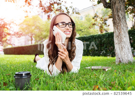 woman in the park with phone 82539645