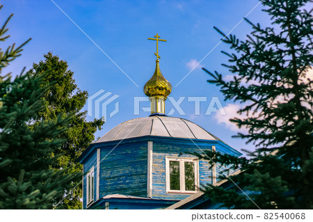 Beautiful christian church with golden domes among green trees. Beautiful christian church with golden domes among green trees. 82540068