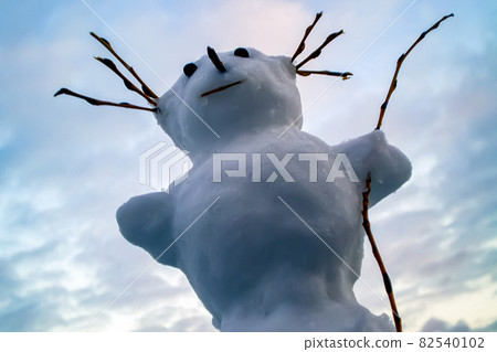 Funny snowman on a background of cloudy sky Funny snowman on a background of cloudy sky 82540102