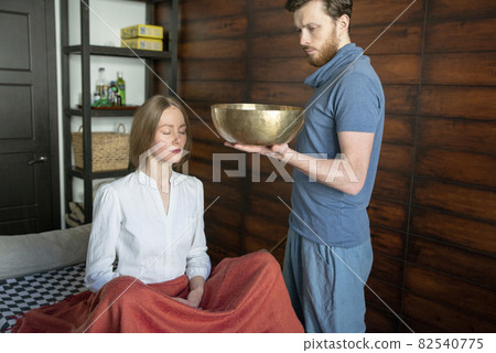 Tibetan singing bowls in sound therapy in spa center 82540775