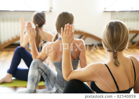 Group of people doing yoga exercise in class 82540859