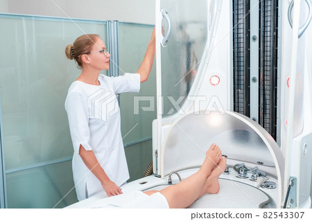Modern spa treatment capsule in cosmetology clinic, cosmetologist operating equipment Modern spa treatment capsule in cosmetology clinic, cosmetologist operating equipment 82543307