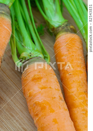 fresh orange carrot with tops close-up spring harvest 82543831
