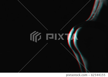 beautiful silhouette of a woman's buttocks on a dark background with a copy space. Black and white with 3D glitch virtual reality effect 82544155