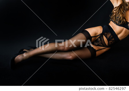 Close-up young beautiful woman isolated over dark studio background. Wellness and cosmetic concept. Close-up young beautiful woman isolated over dark studio background. Wellness and cosmetic concept. 82546297