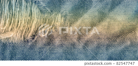Blue denim jean texture background. Jeans torn fabric texture 82547747