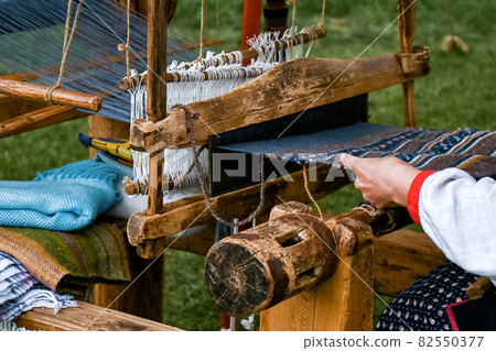 process of creating fabric on an old loom process of creating fabric on an old loom 82550377