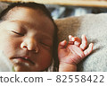 Baby sleeping comfortably on the cushion 82558422