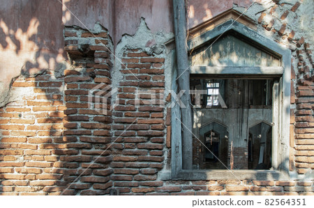 View through a window frame into an abandoned building was left to deteriorate over time. View through a window frame into an abandoned building was left to deteriorate over time. 82564351