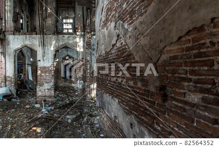 The abandoned building with visible bricks texture was left to deteriorate over time and visible parts of structural elements and ruins. The abandoned building with visible bricks texture was left to deteriorate over time and visible parts of structural elements and ruins. 82564352