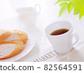 Mug, newspaper and bread 82564591