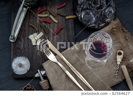 Flat lay composition with pitcher and glasses of red wine and corkscrew on wooden background : traditional winemaking and wine tasting concept. 82564627