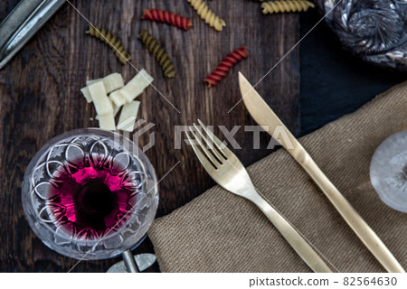Flat lay composition with pitcher and glasses of red wine and corkscrew on wooden background : traditional winemaking and wine tasting concept. 82564630