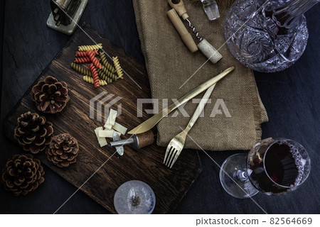 Flat lay composition with pitcher and glasses of red wine and corkscrew on wooden background : traditional winemaking and wine tasting concept. 82564669