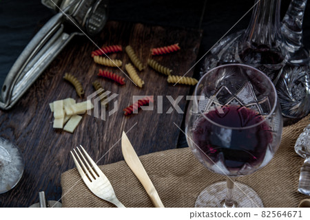 Flat lay composition with pitcher and glasses of red wine and corkscrew on wooden background : traditional winemaking and wine tasting concept. 82564671
