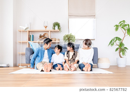 Family of four sitting in the living room Family of four sitting in the living room 82567782