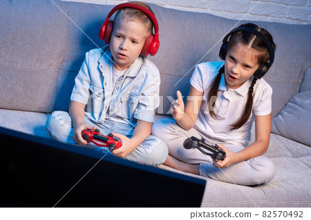 children playing video game with game console children playing video game with game console 82570492