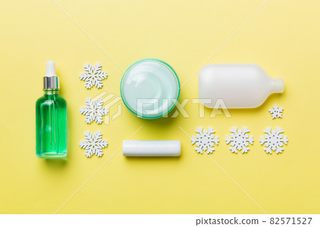 Makeup products and Christmas decorations on color background. Top view New year Beauty concept 82571527