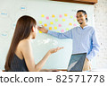 Businesspeople smiling coworking and showing growth graphic and taking a business.Asian business people group present and review financial marketing strategy business plan in meeting room together. 82571778
