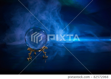 Crystal ball in a dark blue smoky background. Guessing for the future. Crystal ball in a dark blue smoky background. Guessing for the future. 82572068