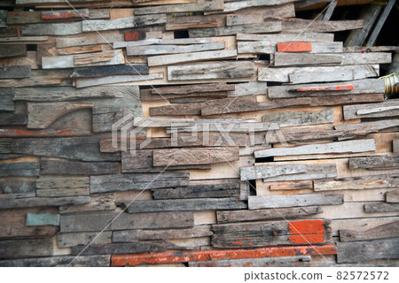 Texture and background of old wooden panels of various colors are arranged together to decorate the building. 82572572