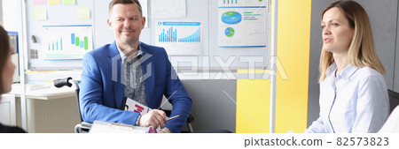 Disabled man discusses business development with business team Disabled man discusses business development with business team 82573823